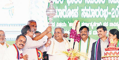 Chief Minister Siddaramaiah poses with a mace during the closing ceremony of the 72nd All-India Cooperation Week celebrations in Chamarajanagar on Thursday  | Express
