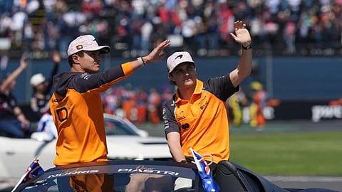 McLaren driver Lando Norris of Britain, left, and teammate Oscar Piastri of Australia, greet spectators during drivers parade before the Formula One Mexico Grand Prix auto race at the Hermanos Rodriguez race track in Mexico City, Sunday, Oct. 26, 2025.