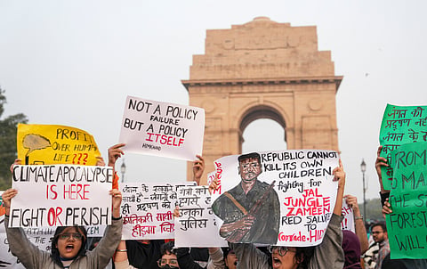  People raise slogans during a protest against worsening air quality in the national capital, at the India Gate, in New Delhi, Sunday, Nov. 23, 2025. 
