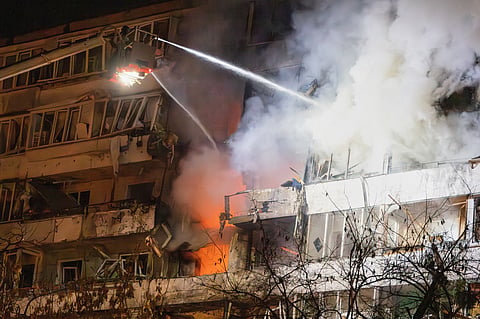 Firefighters put out the fire after a drone hit a multi-storey residential building during Russia's night drone attack in Kyiv, Ukraine, Tuesday, Nov. 25, 2025. 