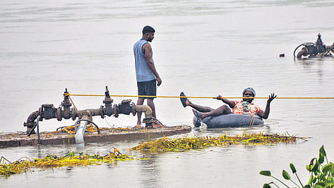Workers fixing a damaged water pipeline in the Thamirabarani river in Tirunelveli on Friday