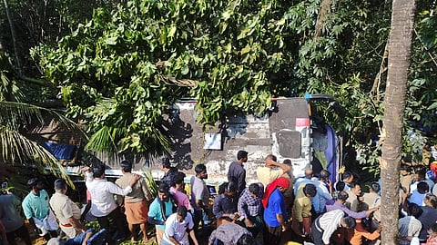 Locals and police at the site where the bus fell into the gorge. 