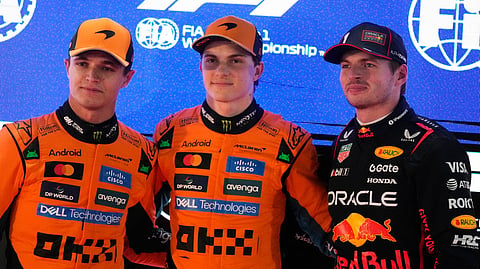 McLaren's Oscar Piastri (C) is flanked by Mclaren's Lando Norris (L), and Red Bull driver Max Verstappen after the second qualifying session at the Lusail International Circuit ahead of the Qatar Formula One Grand Prix, in Lusail, Qatar, Saturday, Nov. 29, 2025.