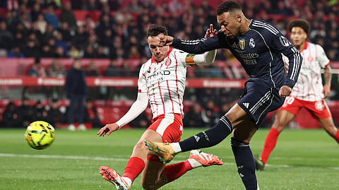 Girona's Arnau Martinez (L) challenges Real Madrid's Kylian Mbappe during the Spanish league football match between Girona FC and Real Madrid CF at Montilivi Stadium in Girona on November 30, 2025. 
