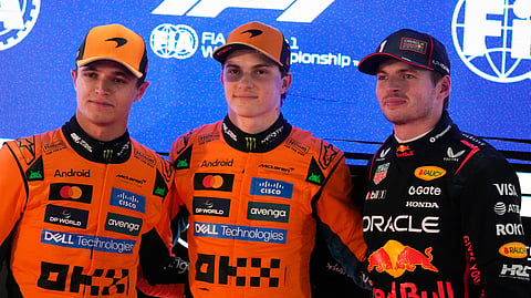 McLaren's Oscar Piastri (C) of Australia is flanked by teammate Lando Norris (L) of Britain and Red Bull's Max Verstappen (R) of the Netherlands after the second qualifying session at the Lusail International Circuit ahead of the Qatar Formula One Grand Prix in Lusail, Qatar, Saturday, Nov. 29, 2025.