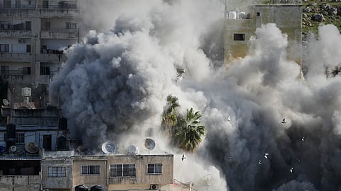 Smoke rises as Israeli forces demolish the home of Abdul Karim Sanoubar, a suspected Palestinian militant who has been accused by Israel of planting bombs on buses in central Israel, in Nablus, West Bank, Tuesday, Dec. 2, 2025