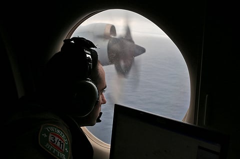 Flight officer Rayan Gharazeddine scans the water in the southern Indian Ocean off Australia from a Royal Australian Air Force AP-3C Orion during a search for the missing Malaysia Airlines Flight MH370 on March 22, 2014. 