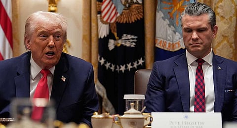 President Donald Trump speaks during a Cabinet meeting at the White House, Tuesday, Dec. 2, 2025, in Washington, as Secretary of Defense Pete Hegseth looks on. 