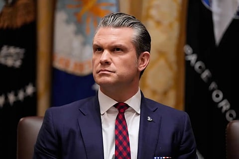 Defense Secretary Pete Hegseth listens as President Donald Trump speaks during a Cabinet meeting at the White House, Tuesday, Dec. 2, 2025, in Washington. 