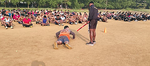 A gathering of around 700 strictly disciplined young men and women pushing their limits, resembling the rigorous drill of an army battalion under the stern eyes of two supervisors. 