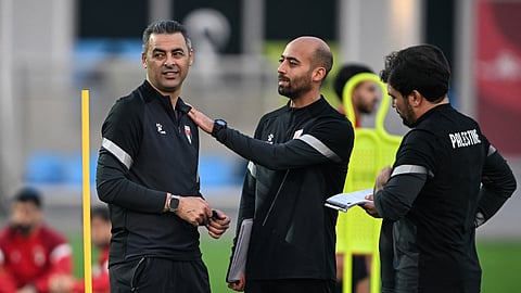 Palestine's head coach Ehab Abu Jaza (L) attends a training session ahead of their FIFA Arab Cup 2025 group stage football match against Syria, in Doha on December 6, 2025. 