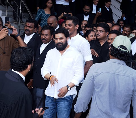 Malayalam actor Dileep emerges from the Ernakulam Principal Sessions Court, surrounded by media and fans, after being acquitted in the 2017 actor abduction case. 