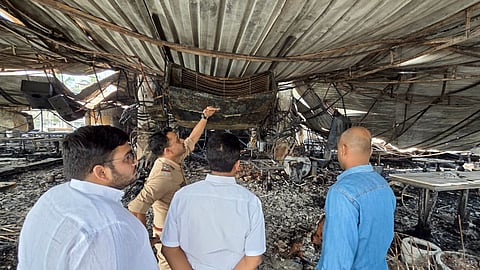 Officials inspect the charred remains of the nightclub after a fire broke out due to a cylinder blast, in North Goa district, Sunday, Dec. 7, 2025. 