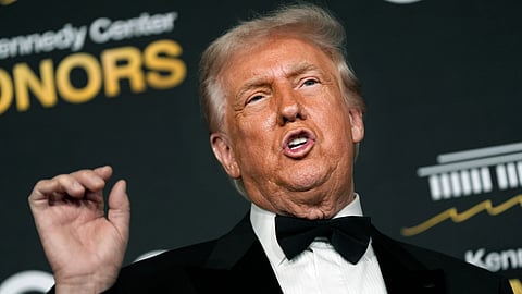 President Donald Trump talks to the media while walking the red carpet before the 48th Kennedy Center Honors, Sunday, Dec. 7, 2025, at the John F. Kennedy Center for the Performing Arts in Washington. 