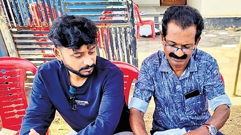 CPM’s K Tulaseedharan Nair (R) at work at their respective party booths in Thiruvananthapuram 