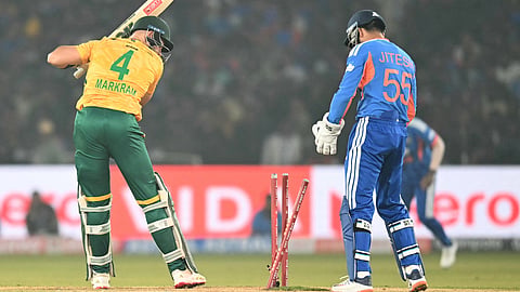 South Africa's captain Aiden Markram (L) is clean bowled during the first Twenty20 international cricket match between India and South Africa at the Barabati Stadium in Cuttack on December 9, 2025.