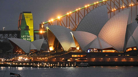 The social media ban for children under 16 with the slogan "Let Them Be Kids" is projected onto the pylons of the Sydney Harbour Bridge in Sydney on Wednesday, Dec. 10, 2025.