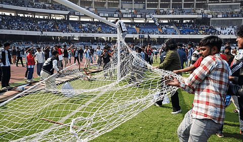 Angry fans on the field as they vandalise the Salt Lake Stadium, alleging poor management during Argentine footballer Lionel Messi's G.O.A.T India Tour 2025, in Kolkata on Saturday. 