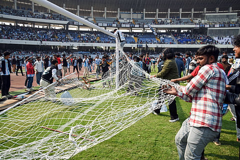 Angry fans on the field as they vandalise the Salt Lake Stadium, alleging poor management during Argentine footballer Lionel Messi's G.O.A.T India Tour 2025, in Kolkata on Saturday. 