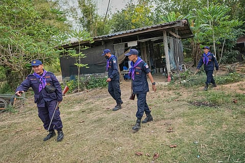 Village security volunteers patrol in the community while villagers have moved to an evacuation center amid the ongoing border conflict between Thailand and Cambodia, in Buriram province, Thailand, Friday, Dec. 12, 2025. 