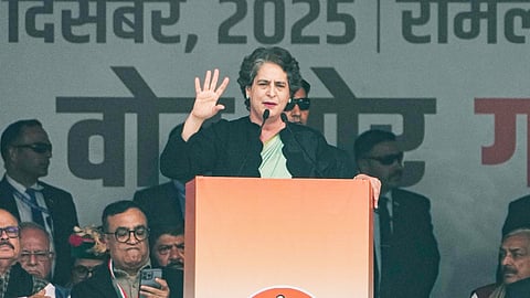 Congress MP Priyanka Gandhi Vadra addresses the gathering during the 'Vote Chor, Gaddi Chhod' rally, at Ramlila Maidan in New Delhi, Sunday, Dec. 14, 2025. 