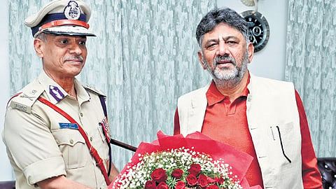 DCM DK Shivakumar greets Director General of Police (Prisons and Correctional services) Alok Kumar at the former’s residence in Bengaluru on Monday. 
