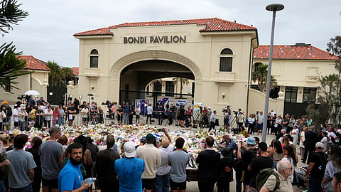 People gather at a floral tribute outside Bondi Pavilion at Bondi Beach on Tuesday, Dec. 16, 2025, following Sunday's shooting in Sydney, Australia. 