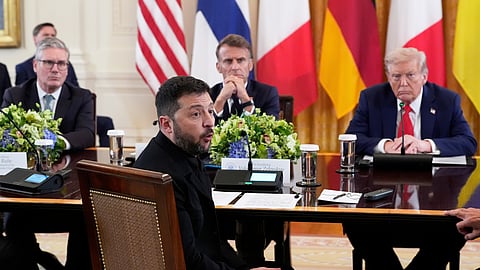 Ukraine's President Volodymyr Zelenskyy speaks as British Prime Minister Keir Starmer, seated from the background left, French President Emmanuel Macron, and US President Donald Trump listen during a meeting in the East Room of the White House, Aug. 18, 2025, in Washington. 