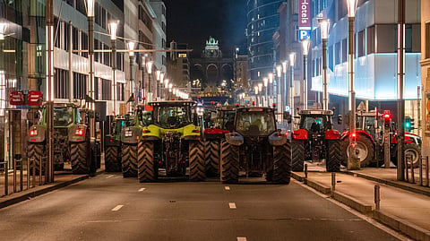Farmers drive their tractors to block a main boulevard during a demonstration outside a gathering of European leaders at the EU Summit in Brussels, Thursday, Dec. 18, 2025. 