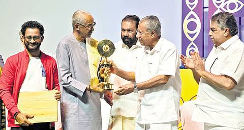 Chief Minister Pinarayi Vijayan presenting the Lifetime Achievement Award to Malian filmmaker Abderrahmane Sissako during the closing ceremony of the 30th IFFK at Nishagandhi auditorium in Thiruvananthapuram on Friday. Chalachitra Academy chairman Resul Pookutty and ministers V Sivankutty and Saji Cherian are also seen 