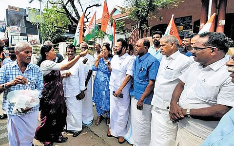 Congress workers led by Palakkad DCC president A Thankappan distribute sweets in front of the Elappully grama panchayat office following the HC verdict on Friday