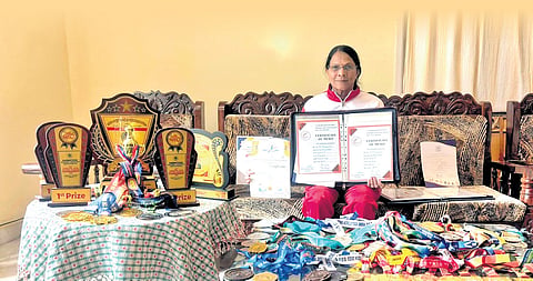 Manjamma B with her certificates, medals and trophies 