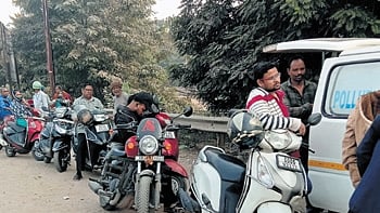 Vehicle owners queue up along the  Kathajodi Ring road near CDA to obtain PUCC, in Cuttack