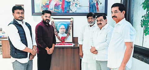 Chief Minister A Revanth Reddy and Deputy Chief Minister Mallu Bhatti Vikramarka pay floral tributes to a portrait of former PM Manmohan Singh in Hyderabad