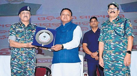 Chief Minister Mohan Charan Majhi receiving the emblem of the SOG Training Centre, Chandaka, from DGP YB Khurania 