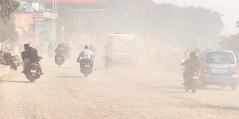 Commuters pass through the dust-filled Kathajodi ring in Cuttack 