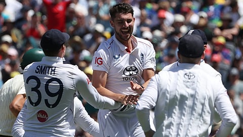England's Josh Tongue, center, celebrates with teammates after taking the wicket of Australia's Scott Boland during their Ashes cricket test match in Melbourne, Friday, Dec. 26, 2025. 