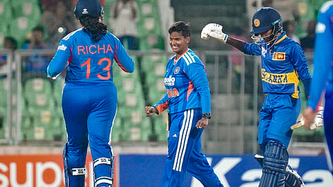 Indias Deepti Sharma, centre, celebrates a wicket with Richa Ghosh, left, during the third T20 International cricket match of a series between India Women and Sri Lanka Women on Dec. 26, 2025. 