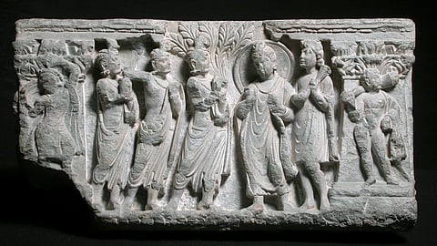 Relief depicting an offering of flowers to Budhha; Gandharan art from Swat, Pakistan 