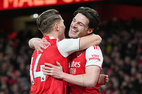 Arsenal's Viktor Gyoekeres and Arsenal's Declan Rice celebrate after Brighton's Georginio Rutter scored an own goal during the English Premier League soccer match between Arsenal and Brighton and Hove Albion in London, Saturday, Dec. 27, 2025. 