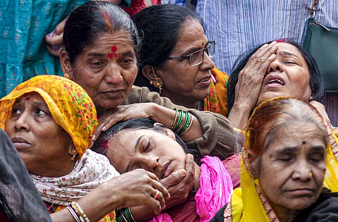 Family members of a victim, who died after consumption of allegedly contaminated water, mourn in the Bhagirathpura area of Indore, Madhya Pradesh.