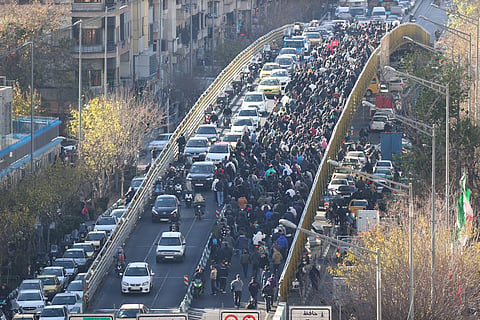 Protesters march in downtown Tehran, Iran, Monday, December. 29, 2025. 