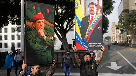 Government supporters display posters of Venezuelan President Nicolás Maduro, right, and former President Hugo Chávez in downtown Caracas, Venezuela, Saturday, Jan. 3, 2026, after U.S. President Donald Trump announced that Maduro had been captured and flown out of the country.