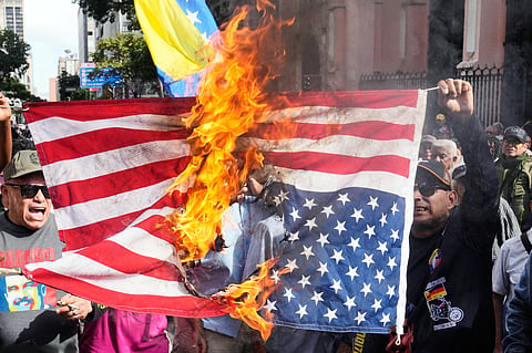Government supporters burn a US flag in Caracas, Venezuela, Saturday, Jan. 3, 2026, after US President Donald Trump announced that US forces had captured Venezuelan President Nicolás Maduro and his wife.