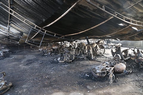 Burnt two-wheelers seen at the parking area of Thrissur railway station following Sundays fire.