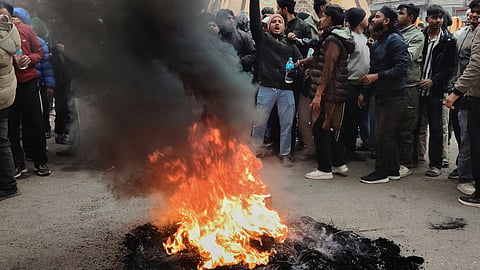Protesters shout slogans and burn tires as they block main Street in Birgunj, 130 kilometers (81miles) south of Katmandu, Nepal, Sunday, Jan. 4, 2026. 