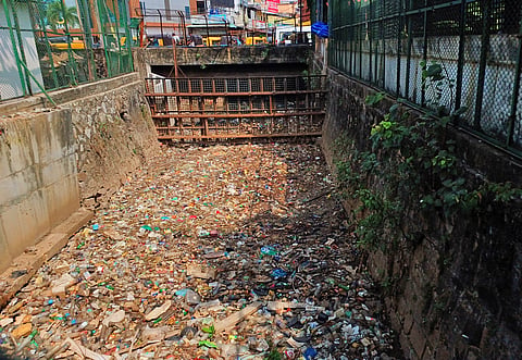 Amayizhanjan canal seen clogged with junk near Central Railway station in Thampanoor on Wednesday