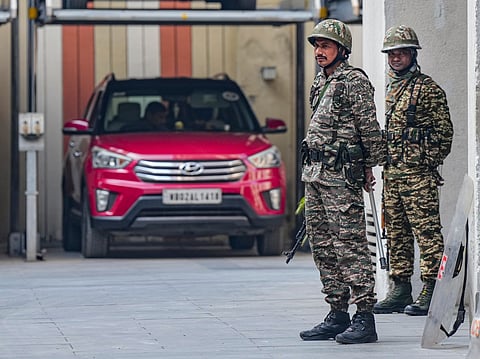 Security personnel keep vigil during a raid by the Enforcement Directorate (ED) at the residence of Pratik Jain, director of political consultancy firm I-PAC, as part of a money laundering investigation, in Kolkata, Thursday, Jan. 8, 2026. 