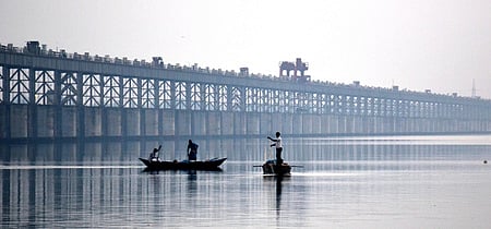 Fishermen casting their nets in Mahanadi river near Jagatpur in Cuttack on Friday.