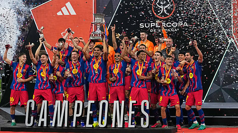 Barcelona players celebrate after winning the Spanish Super Cup final soccer match against Real Madrid at King Abdullah Sports City Stadium in Jeddah, Saudi Arabia, Sunday, Jan. 11, 2026. 